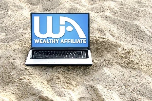 Wealthy Affiliate laptop on beach